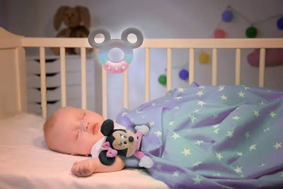 Enfant dormant avec le projecteur interactif Baby Minnie